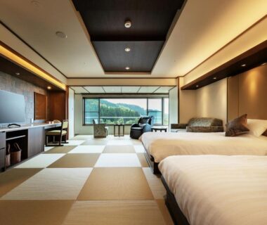 Spacious tatami-floored twin room with seating area and mountain view at Zao Shiki no Hotel, Yamagata