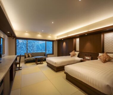 Spacious tatami-floored twin room with large window at Zao Shiki no Hotel, Yamagata