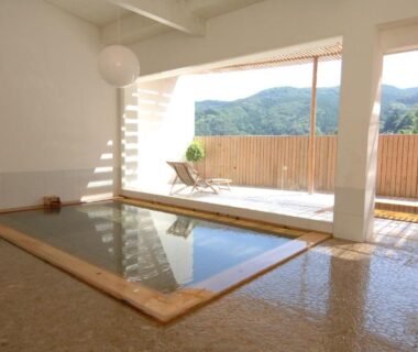 Indoor onsen bath with sliding windows and mountain view at Zen no Yu Shizuoka