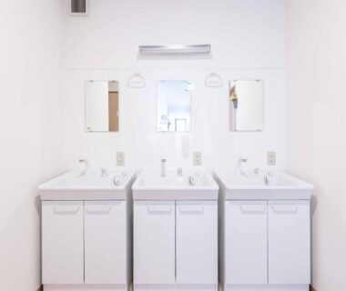Three white sinks and mirrors in communal wash area at add-Hostel Uji Cha-gan-ju-tei Kyoto
