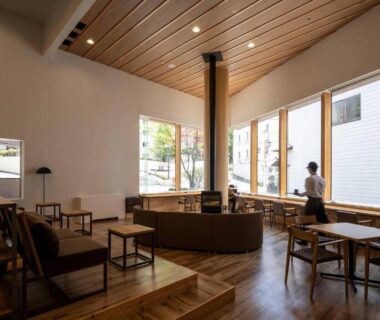 Central wood stove in airy lounge at adex Inn Hokkaidō Japan