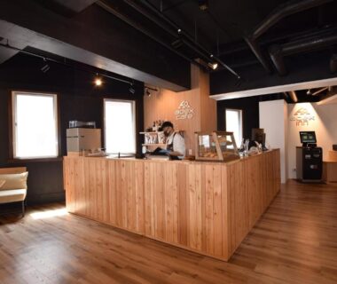 Wooden check-in desk and seating area at adex Inn in Hokkaidō