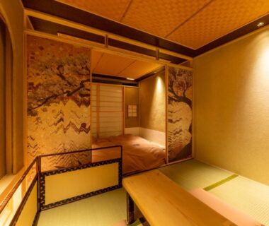 Traditional tatami room with low table and painted fusuma at cyashitsu ryokan asakusa in Tokyo