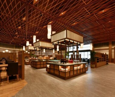 Spacious dining area with wooden lattice ceiling, lantern lights and buffet stations at jyozankei SHIKAnoYU in Hokkaidō