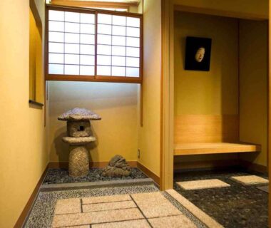 Traditional genkan with stone lantern, pebble flooring, shoji window and wooden bench at a ryokan in Ishikawa, Chūbu