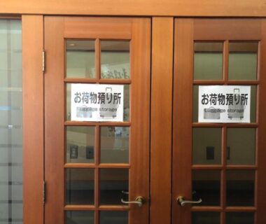 Double wooden doors with Japanese luggage storage signs at Kinugawaonsen Fukumatsu, Tochigi