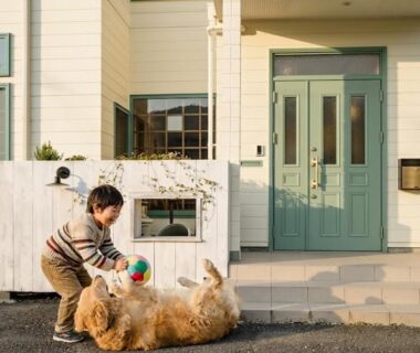 Child playing with large dog outside Koyado Kaziya entrance in Iwate Tōhoku