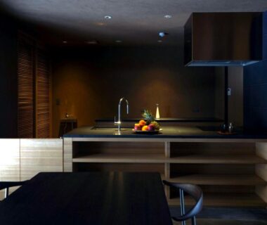 Dark minimalist kitchenette with sink, countertop and dining table at kutokuan in Gifu, Chūbu, Japan
