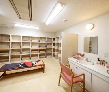 Changing room with bench, vanity sinks and shelving at mt inn in Fukushima Tohoku