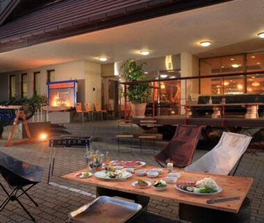 Nighttime outdoor courtyard dining with low tables and chairs at mt. inn in Fukushima, Tohoku
