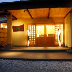Warm lit entrance with shoji screens at nanaougi in Kanagawa, Kantō Japan