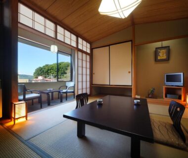 Traditional tatami room with low table, zabuton seating and shoji doors opening to garden view