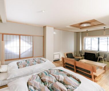 Two futon beds and seating area with shoji screens at onogawaonsen azumasou in Yamagata Tōhoku