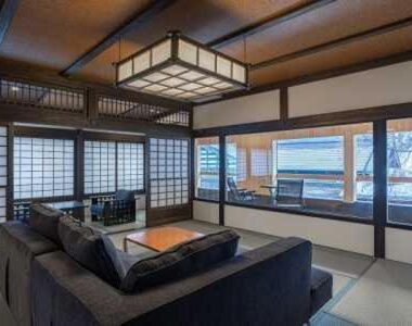 Tatami lounge with shoji screens and low table at ryugon in Chūbu, Niigata, Japan