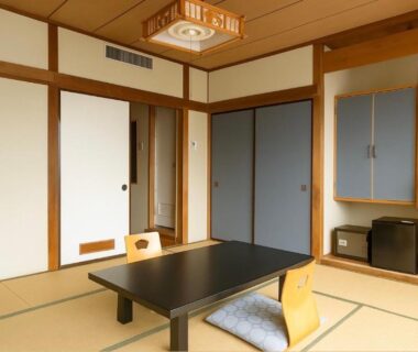 Traditional tatami room with low table, zabuton chairs and shoji screens at soraichi, Miyagi