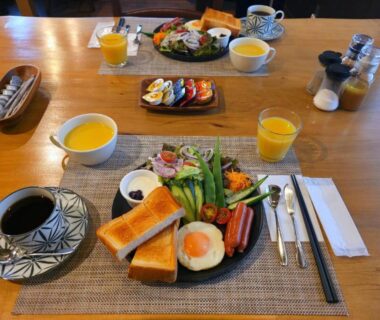 Breakfast spread with toast, fried egg, sausages, salad, coffee and juice at Ryokan Uribō in Gunma Kantō