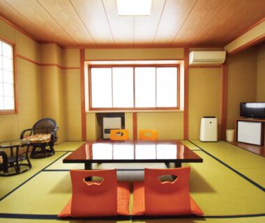 Tatami room with low table and zabuton cushions at Oyado Kokoro in Gifu
