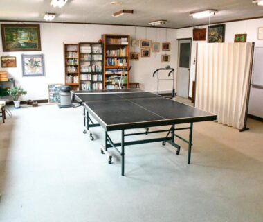 Indoor recreation room with table tennis, benches and bookshelf at Oyado Marutoya, Nagano, Chūbu, Japan