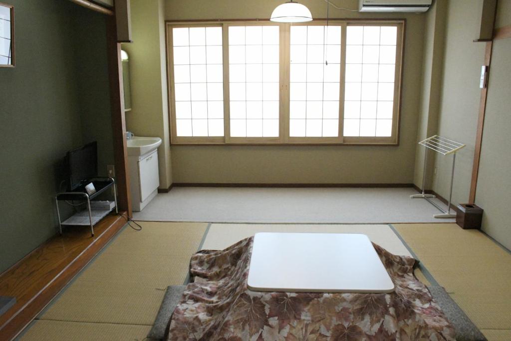 Tatami Room Oyado Marutoya Nagano Japan Tatami room with kotatsu and shoji screens at Oyado Marutoya in Nagano, Chūbu, Japan