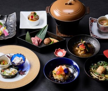 Assorted small Japanese dishes and lacquerware on a black table at Oyado Andon Toba Mie