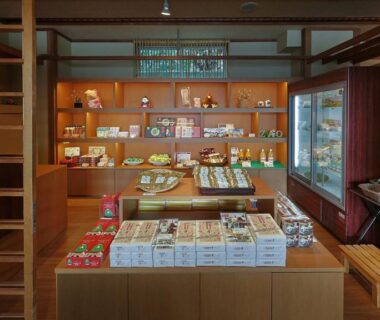 Interior view of ryokan gift shop with wooden shelves and packaged local souvenirs in Miyagi Tōhoku