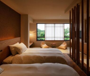 Twin beds, shoji window, low seating by window at Kuroshio Sō in Wakayama, Kansai, Japan