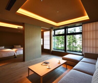 Tatami sitting area with low table, sofa, and shoji screens at Tsurukō in Ishikawa, Chūbu Japan
