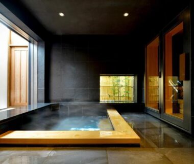 Steaming indoor wooden-framed onsen bath at Tsurukō ryokan in Chūbu, Ishikawa, Japan