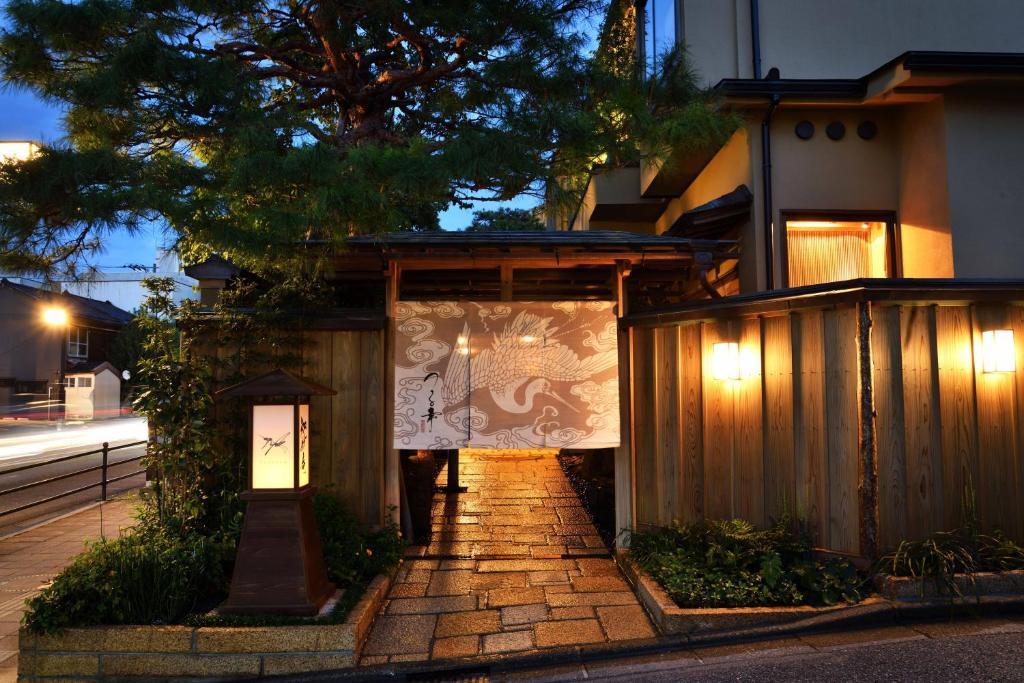 Lit entrance at Tsurukō, Ishikawa Chūbu Stone pathway, noren curtain and lanterns at Tsurukō in Ishikawa, Chūbu