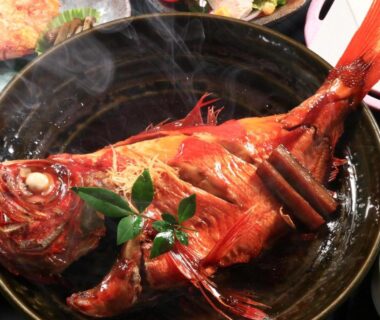 Whole steaming simmered fish garnished in a black bowl, served at Fukabe ryokan in Shizuoka