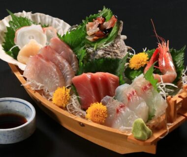 Assorted sashimi on wooden boat with scallop, tuna, shrimp and wasabi at Fukabe, Shizuoka, Chūbu Japan