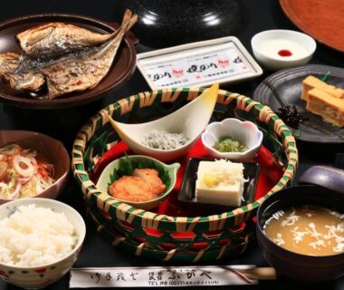 Tray of traditional Japanese dishes with grilled fish, rice, miso and side dishes at Fukabe ryokan