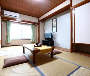 Tatami room with low table and cushions at Fukabe ryokan in Shizuoka, Chūbu, Japan