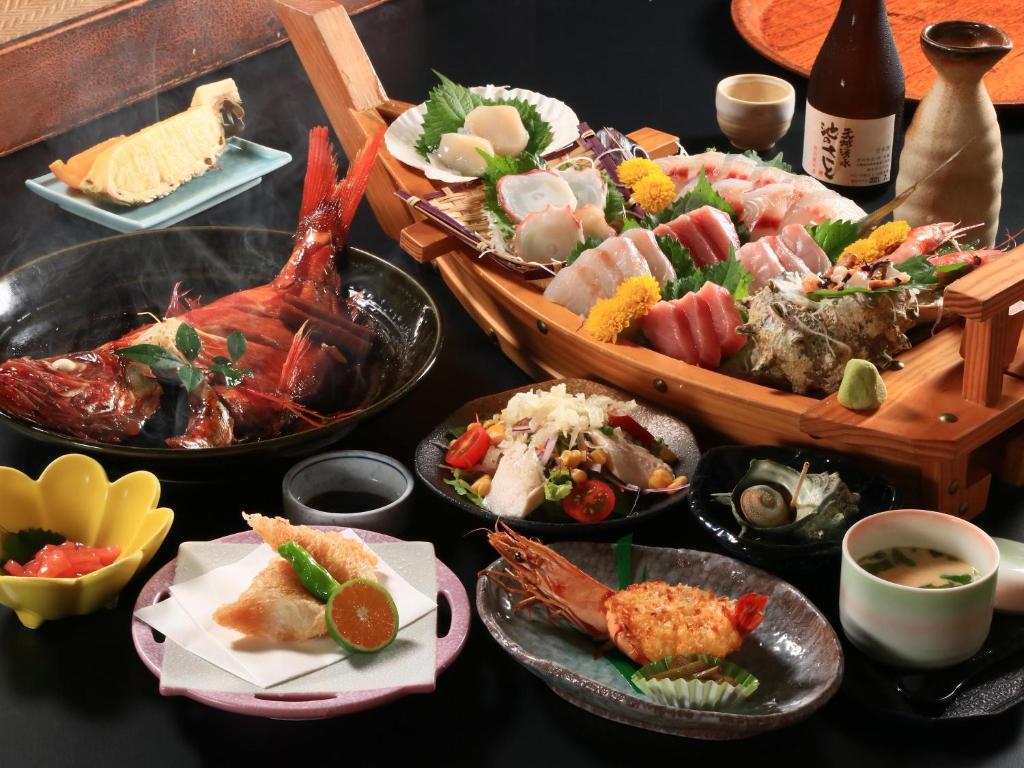 Seafood Multi-course Meal at Fukabe Shizuoka Assorted sashimi boat with grilled seafood, side dishes and sake at Fukabe in Shizuoka