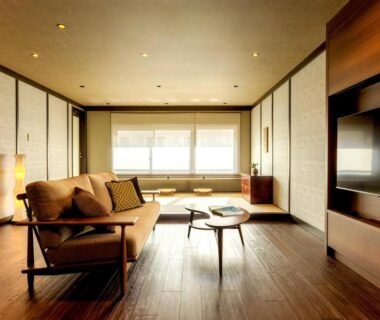 Interior lounge with wooden flooring, sofa and shoji screens at MACHIYADO ICHIRYU, Chūbu Gifu Japan