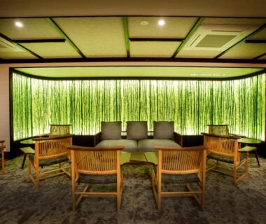 Backlit bamboo wall lounge with wooden chairs at MACHIYADO ICHIRYU in Gifu, Chūbu