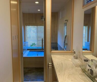 En-suite vanity and sliding door leading to soaking tub at Auberge Hanagoyomi, Shizuoka, Chūbu, Japan