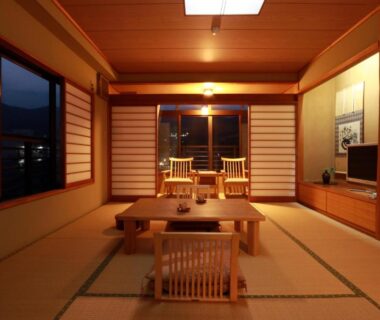 Tatami room with low table, shoji screens and window views at Auberge Hanagoyomi in Shizuoka