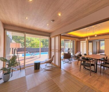 Spacious tatami-floored lounge with dining area and sliding doors to outdoor pool and garden
