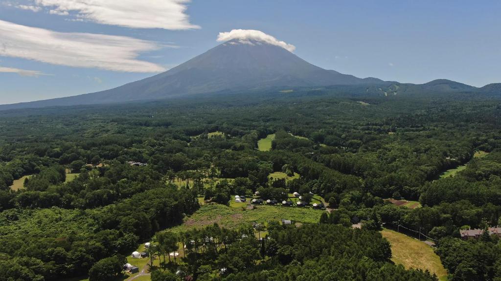 Mount Fuji Aerial View Glamping Kawaguchiko Aerial view of Mount Fuji above forested Kawaguchiko landscape with glamping tents and grassy sites