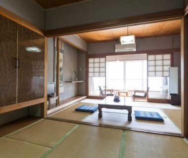 Tatami room with low table, zabuton cushions and shoji screens at Seaside Katsuragahama-sō, Hiroshima