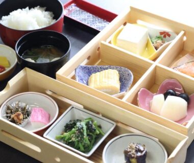 Wooden multi-compartment bento with small dishes, rice and miso soup at Seaside Katsuragahama-sō Hiroshima Japan