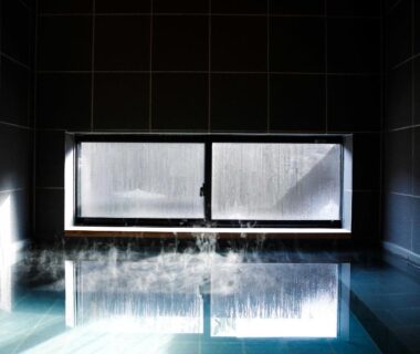 Steam rising from indoor tiled onsen bath at Hitotsuru in Setouchi, Hiroshima