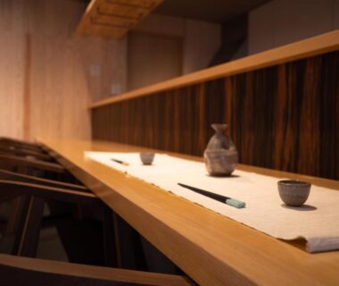 Long wooden counter with ceramic cups and chopsticks at Hitotsuru ryokan in Setouchi Hiroshima