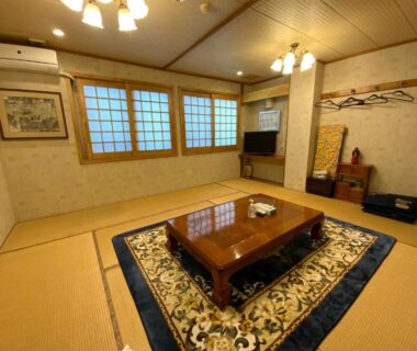 Tatami room with low table and shoji windows at Business Inn Haijima, Tokyo