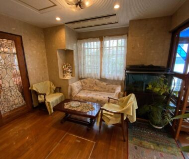 Lobby seating area with sofa, stained glass door, aquarium and wooden flooring at Business Inn Haijima, Tokyo