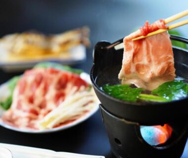Thinly sliced meat cooking in a tabletop hot pot at Piporo Norikura ryokan in Nagano
