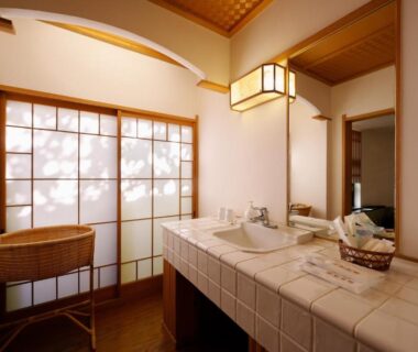 Tiled sink counter and wicker chair with shoji screen at Sanpei-sō ryokan in Shizuoka, Chūbu