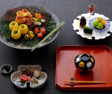 Assorted small Japanese dishes on lacquer tray and ceramic plates with chopsticks
