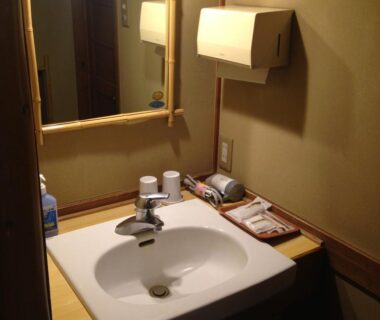 Sink with mirror, paper towel dispenser and toiletries at Nakadana-sō in Chūbu, Nagano, Japan